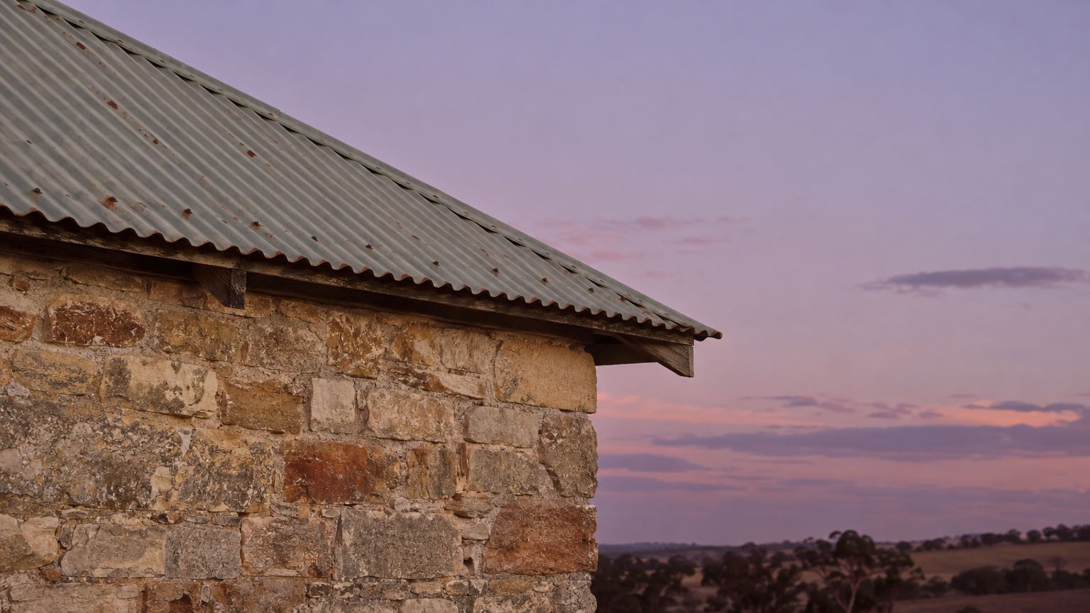 The roofline at dusk as the evening begins